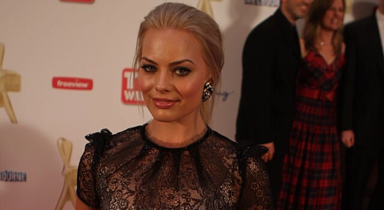 Margot Robbie sul red carpet di un evento nel 2011 che guarda in camera e sorride con un vestito nero trasparente di pizzo