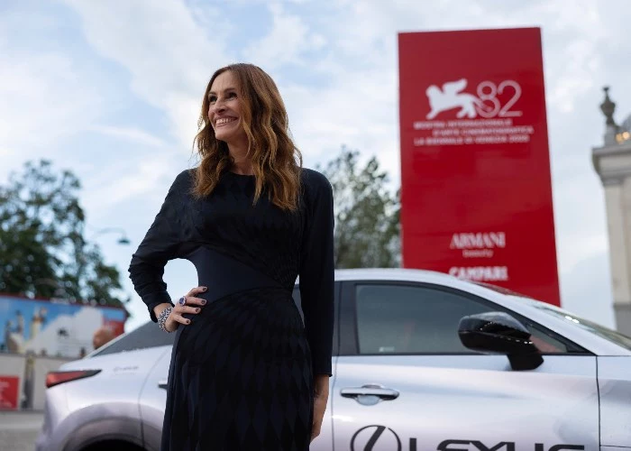 Julia Roberts sul red carpet di Venezia 82 che sorride con una mano appoggiata su un fianco - Pretty Woman cinema