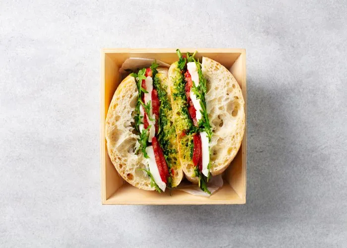 Un panino mozzarella, pomodoro e pesto basilico