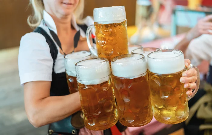 Cameriera con boccali di birra durante una festa in stile bavarese
