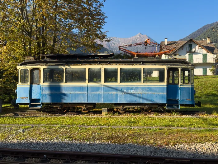 Carrozza ferroviaria d'epoca azzurra su una linea storica di montagna